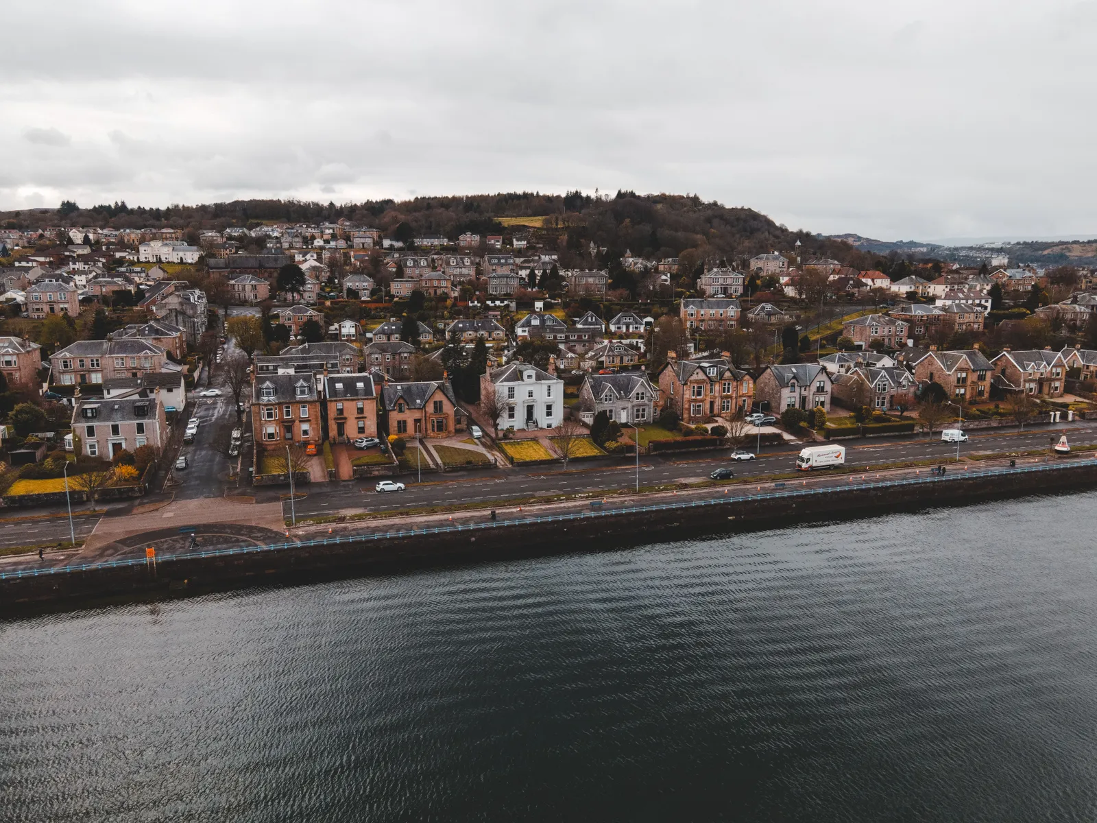The Greenock Esplanade from the air, a line of villas facing the sea wall on the Firth of Clyde