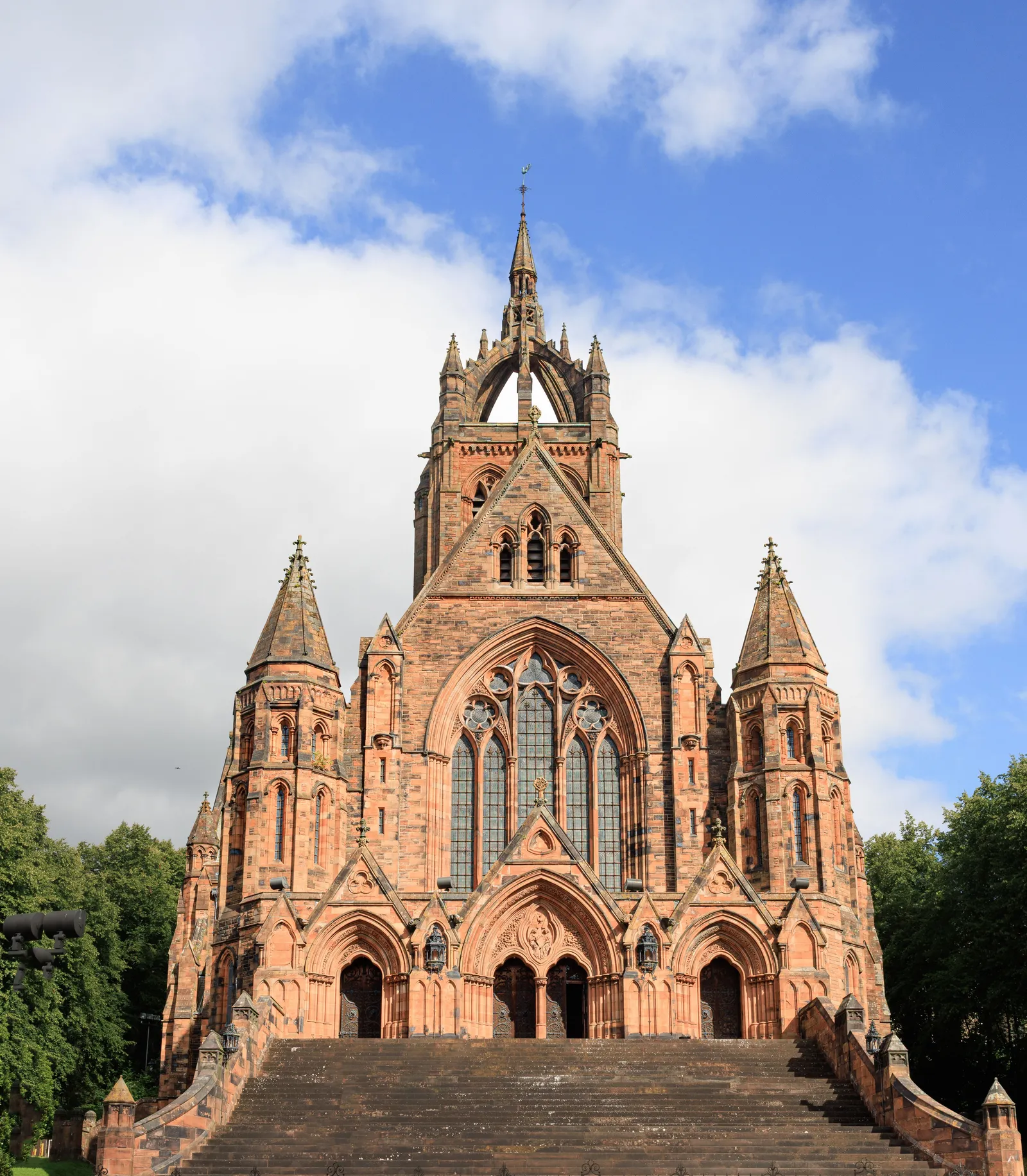 The Thomas Coats Memorial Church in Paisley, red sandstone with a crowned spire, seen from the foot of its front steps